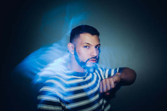 Handsome bearded man dancing in spotlight