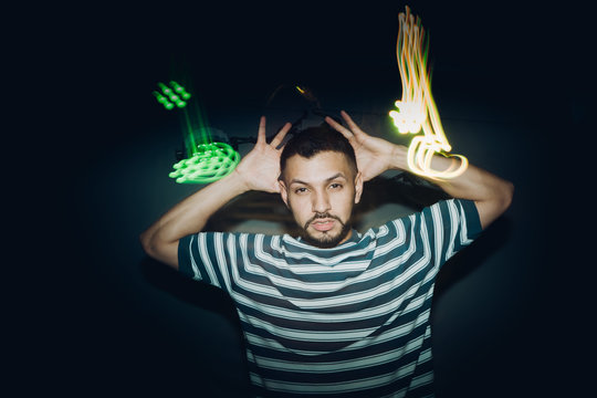 Handsome bearded man dancing in spotlight