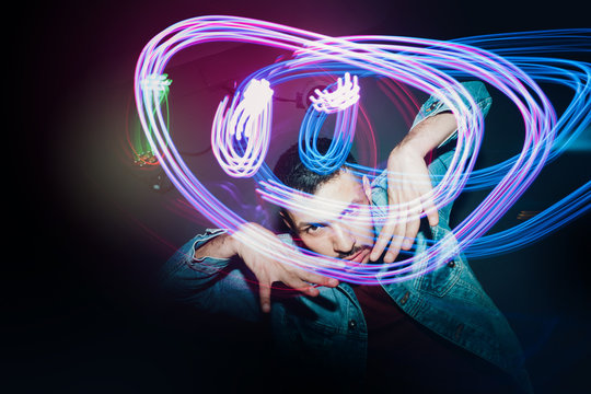 Handsome bearded man dancing in spotlight