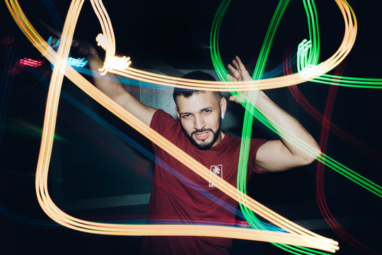 Handsome bearded man dancing in spotlight