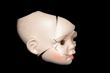Broken Doll Head Face On Black Background