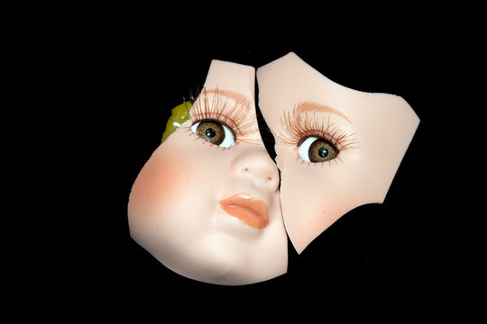 Broken Doll Head Face On Black Background