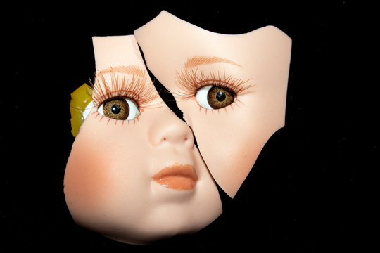 Broken Doll Head Face On Black Background