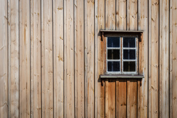 Obraz na płótnie Canvas The old window of old wooden house. Background of wooden walls