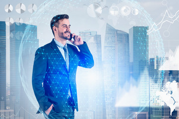 Smiling young man on phone in city, global world