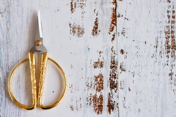 Scissors with gold handles.