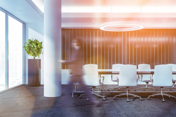 Man walking in white meeting room