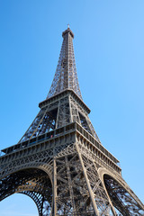 Eiffel Tower in Paris in a sunny day, low angle view and clear blue sky