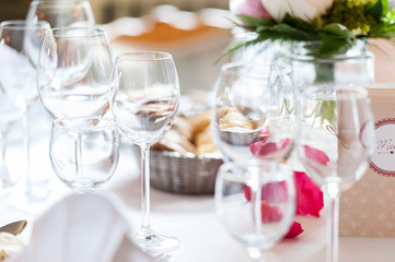 multiple empty glasses on table in bright atmosphere