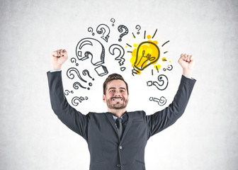 Winner businessman, question marks and light bulbs