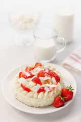 Delicate strawberry cheesecake with coconut. Delicious homemade cake with Fresh berries on light table.