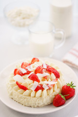 Delicate strawberry cheesecake with coconut. Delicious homemade cake with Fresh berries on light table.
