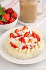 Delicate strawberry cheesecake with coconut. Delicious homemade cake with Fresh berries on light table.