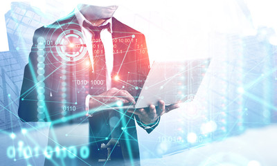 Man with laptop in server room, HUD interface