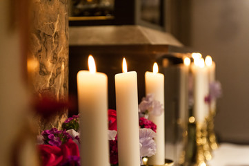 big candles burning in the church with blurred background