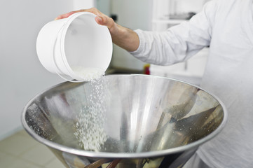 work sleeps coconut chips in an industrial crusher - press. Food production