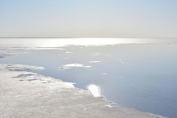 Frozen sea at sunny day.