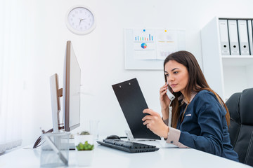 Businesswoman on her workplace having a conversation