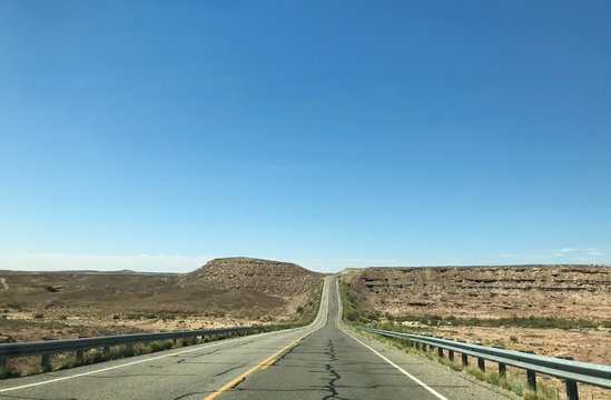 An empty desert highway photo taken on a beautiful sunny day