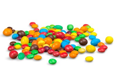 Fototapeta na wymiar Colorful candies sweets falling out of a glass jar, composition isolated over the white background