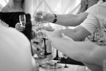 hands of man with glass of wine