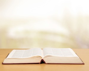 Open Holy bible book on background
