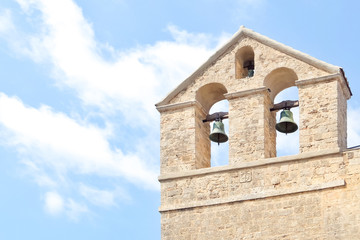 Tarquinia, Italy. Sunny day in Tarquinia. Bells of catholic church (Chiesa di Santa Maria in Castello ). XI century.