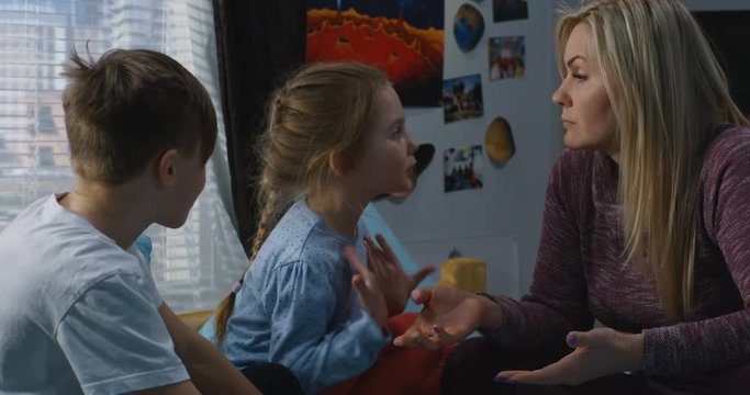 Mother talking with bickering siblings