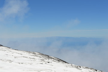 View from the slopes of Mount Etna with laughter and clouds, Sicily, Italy