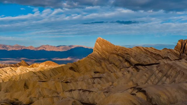 Sunrise at Zabriskie Point - Time-lapse video of sunrise view of Manly Beacon and surrounding rock formations, as Spring morning clouds passing over. Zabriskie Point, Death Valley National Park, CA.