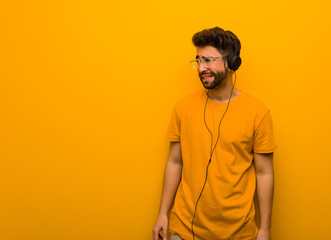 Young man listening to music thinking about an idea
