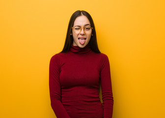 Fototapeta premium Intellectual young girl funnny and friendly showing tongue