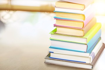 Colorful books collection on background.