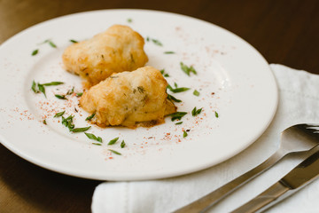 Tasty dinner. Rolls on a plate with grass and seasonings.