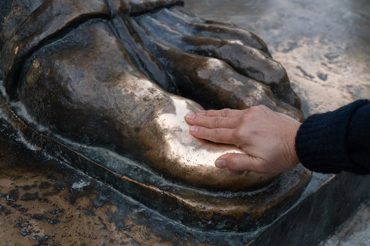 Unidentified hand rubbed Grgur Ninski toe and make a wish in Split Croatia