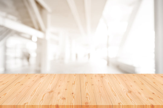 Empty wooden table top with blurred of coffee shop, cafe, bar background, Abstract background can be used for display or montage your products.
