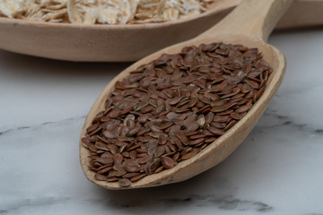 Seeds on a wooden spoon close up