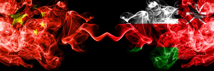 China vs Oman, Omani smoke flags placed side by side. Thick colored silky smoke flags of Chinese and Oman, Omani
