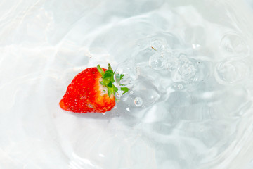 bright red ripe strawberries under water