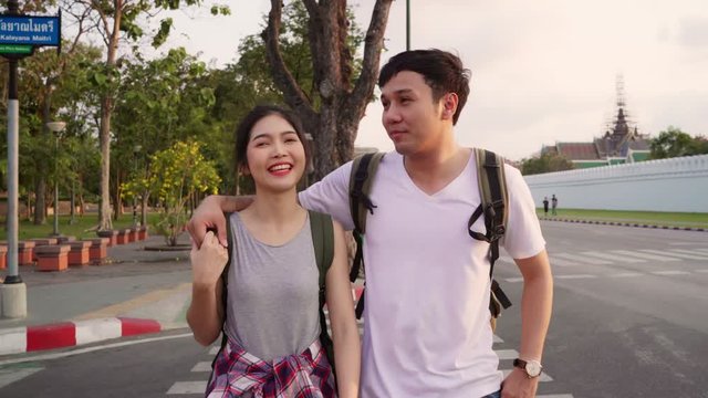 Traveler Asian couple traveling and walking in Bangkok, Thailand, sweet Asia couple feeling happy spending sweet time in holiday trip in sunset. Lifestyle couple travel in city concept.
