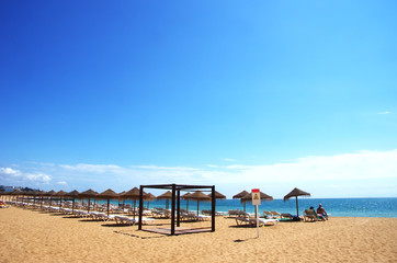 Fototapeta premium Beach with sunbeds and umbrellas, Albufeira, Portugal