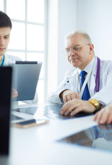 Fototapeta premium Medical team sitting and discussing at table