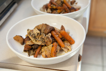 Two white plates of fresh homemade chicken stew ready to be served