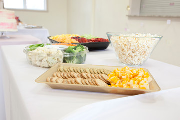 able at a party with popcorn, fruit, cheese and other gluten free snacks