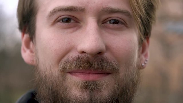 Young bearded man looking at the camera and smiling