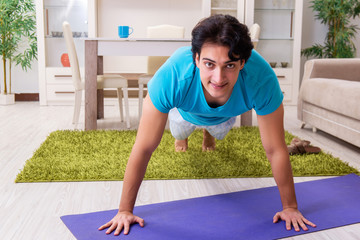 Fototapeta premium Young handsome man doing morning exercises 