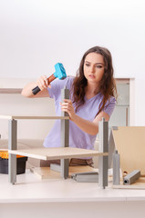 Young woman repairing chair at home 