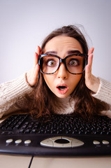 Funny nerd girl working on computer