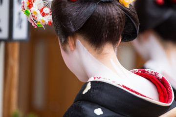 A traditional geisha out and about walking in Gion Kyoto Japan .