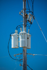 Electric pole with a transformer and wires